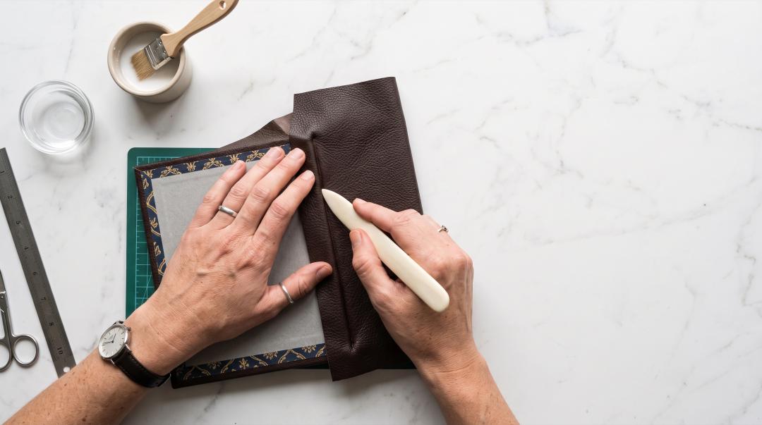 A pair of hands crafting a set of gifts